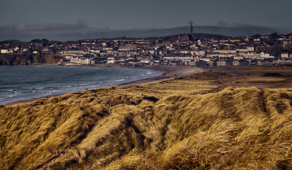 View of sand dunes and town of Tramore, Co Waterford, Ireland