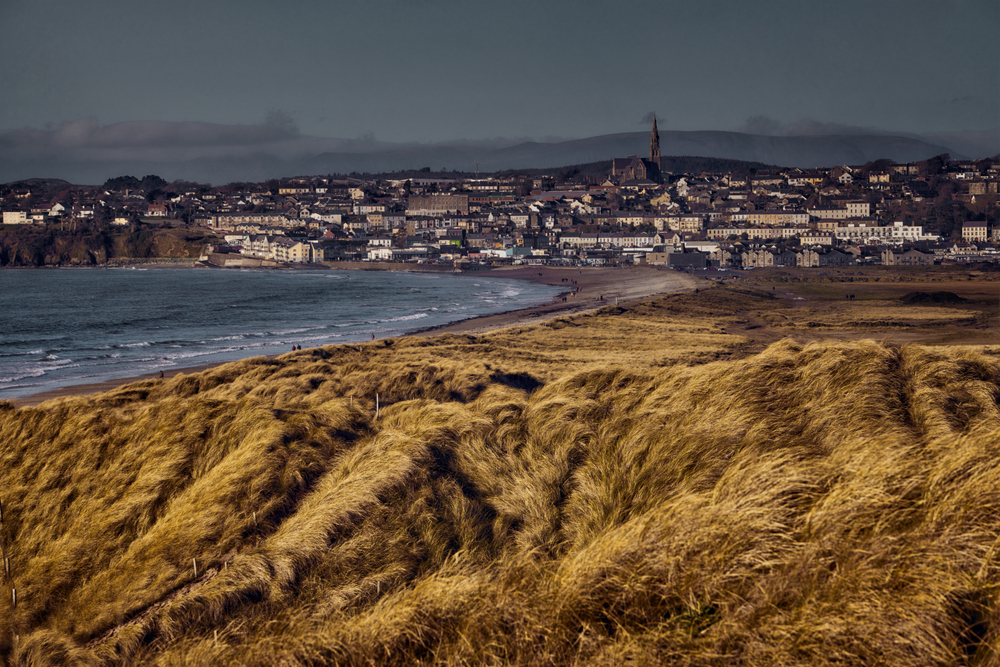 View of sand dunes and town of Tramore, Co Waterford, Ireland